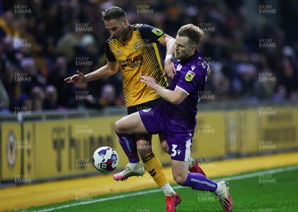 140223 - Newport County v Stevenage, EFL Sky Bet League 2 - Cameron Norman of Newport County is challenged by Max Clark of Stevenage