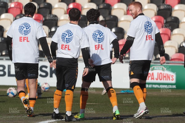 270221 - Newport County v Stevenage - Sky Bet League 2 - Newport Players warm up wearing EFL / Level Playing Field t-shirts supporting disability inclusion in sport