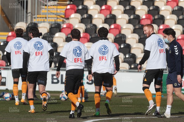 270221 - Newport County v Stevenage - Sky Bet League 2 - Newport Players warm up wearing EFL / Level Playing Field t-shirts supporting disability inclusion in sport