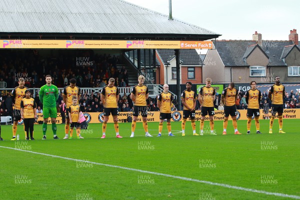121122 - Newport County v Stockport County - Sky Bet League 2 - Players of Newport County pay their respects before kick off