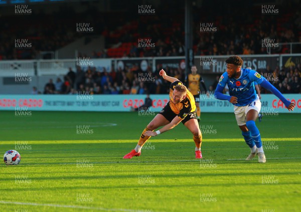 121122 - Newport County v Stockport County - Sky Bet League 2 - Cameron Norman of Newport passes under pressure from Myles Hippolyte of Stockport