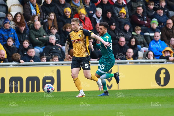 250223 - Newport County v Sutton United - Sky Bet League 2 - James Clarke of Newport County takes on Donovan Wilson of Sutton United