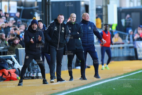 250223 - Newport County v Sutton United - Sky Bet League 2 - Manager of Newport County Graham Coughlan (23) and Manager of Sutton United Matt Gray (R) look on  