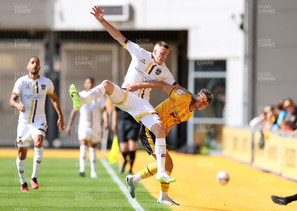 260823 - Newport County v Sutton United - SkyBet League Two - Ben Goodliffe of Sutton United and Seb Palmer-Houlden of Newport County go into touch