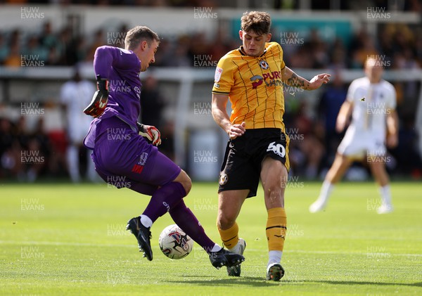 260823 - Newport County v Sutton United - SkyBet League Two - Jack Rose of Sutton United is challenged by Seb Palmer-Houlden of Newport County 