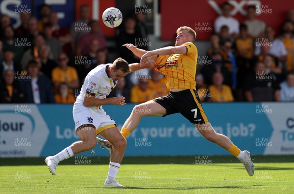 260823 - Newport County v Sutton United - SkyBet League Two - Robert Milsom of Sutton United is challenged by Will Evans of Newport County 