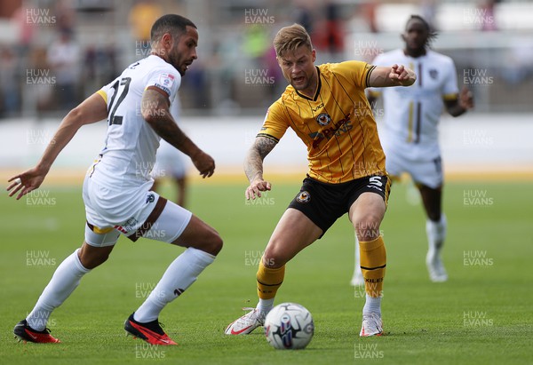 260823 - Newport County v Sutton United - SkyBet League Two - Joe Kizzi of Sutton United is challenged by James Clarke of Newport County 