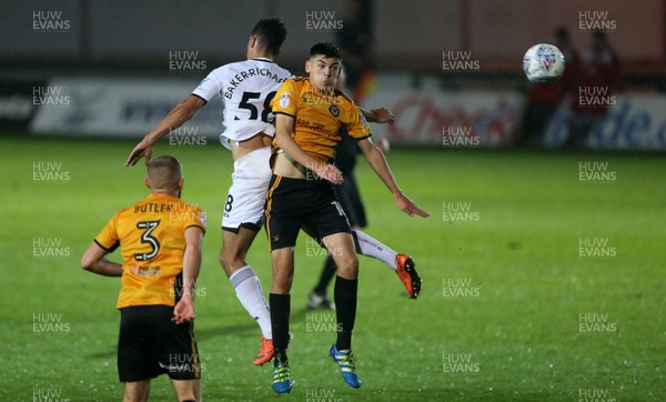 101017 - Newport County v Swansea City U23s - Checkatrade Trophy - Courtney Baker-Richardson of Swansea City and Jay Foulston of Newport County go up for the ball