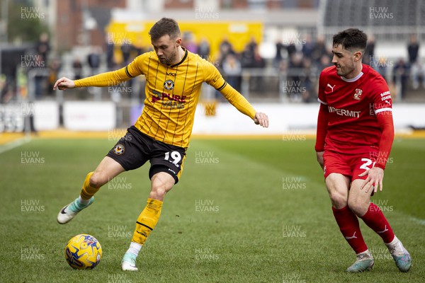 030224 - Newport County v Swindon Town - Sky Bet League 2 - Shane McLoughlin of Newport County in action against Conor McCarthy of Swindon Town
