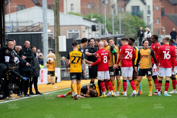 040223 - Newport County v Swindon Town - Sky Bet League 2 - Cameron Norman of Newport County on the floor after a push from Rushian Hepburn-Murphy of Swindon Town, who was sent off by referee Neil Hair