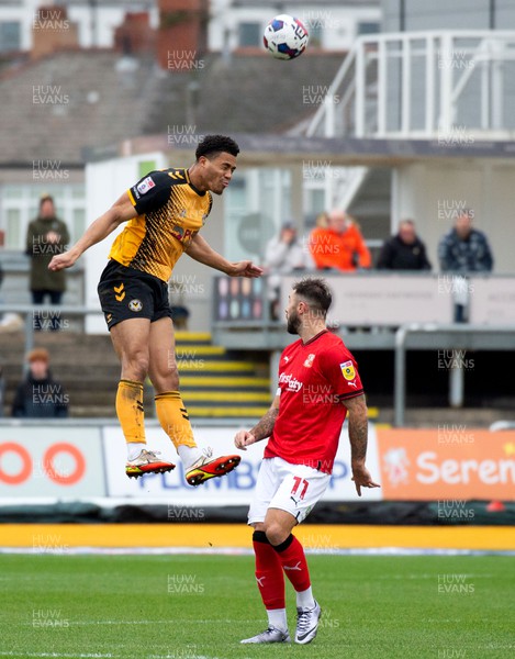 040223 - Newport County v Swindon Town - Sky Bet League 2 - Priestley Farquharson of Newport County heads above Charlie Austin of Swindon Town 