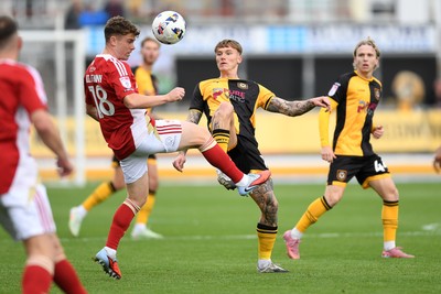 041025 - Newport County v Swindon Town - Sky Bet League 2 - Kai Whitmore of Newport County is challenged by Gavin Kilkenny of Swindon