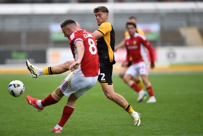 041025 - Newport County v Swindon Town - Sky Bet League 2 - Cameron Evans of Newport County is challenged by Ollie Clarke of Swindon