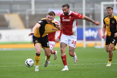 041025 - Newport County v Swindon Town - Sky Bet League 2 - Lee Jenkins of Newport County is challenged by Ollie Palmer of Swindon