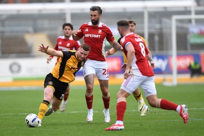 041025 - Newport County v Swindon Town - Sky Bet League 2 - Lee Jenkins of Newport County is challenged by Ollie Palmer of Swindon