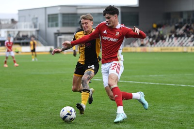 041025 - Newport County v Swindon Town - Sky Bet League 2 - Kai Whitmore of Newport County is challenged by Jamie Knight-Lebel of Swindon