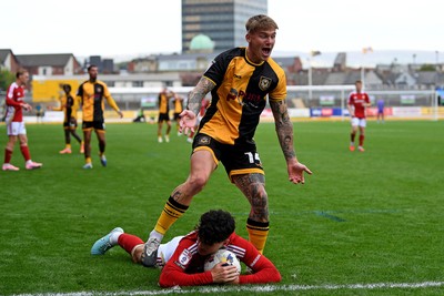 041025 - Newport County v Swindon Town - Sky Bet League 2 - Kai Whitmore of Newport County is challenged by Jamie Knight-Lebel of Swindon