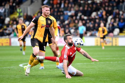 041025 - Newport County v Swindon Town - Sky Bet League 2 - Lee Jenkins of Newport County is challenged by Ollie Palmer of Swindon