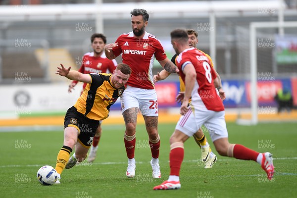 041025 - Newport County v Swindon Town - Sky Bet League 2 - Lee Jenkins of Newport County is challenged by Ollie Palmer of Swindon
