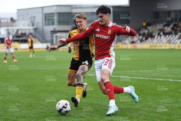 041025 - Newport County v Swindon Town - Sky Bet League 2 - Kai Whitmore of Newport County is challenged by Jamie Knight-Lebel of Swindon