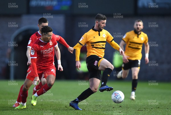 090419 - Newport County v Swindon Town - SkyBet League 2 - Padraig Amond of Newport County is tackled by Kyle Knoyle of Swindon Town