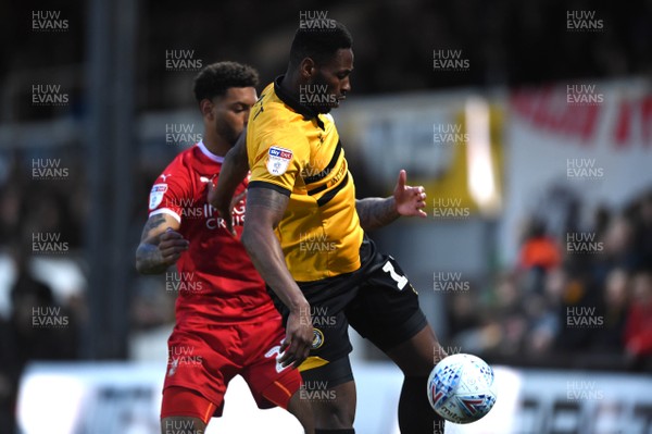 090419 - Newport County v Swindon Town - SkyBet League 2 - Jamille Matt of Newport County is tackled by Kaiyne Woolery of Swindon Town