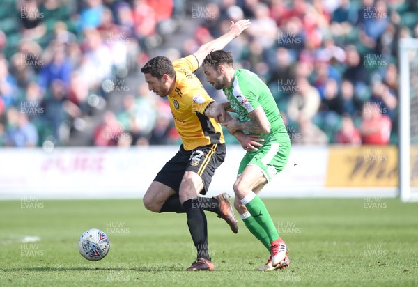 140418 - Newport County v Swindon Town - SkyBet League 2 - Ben Tozer of Newport County and James Dunne of Swindon Town compete