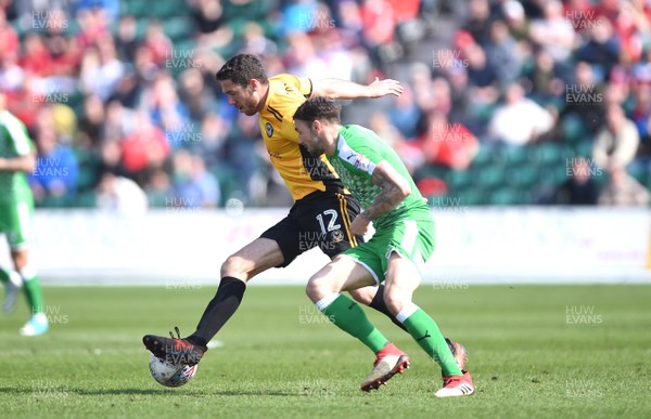 140418 - Newport County v Swindon Town - SkyBet League 2 - Ben Tozer of Newport County and James Dunne of Swindon Town compete