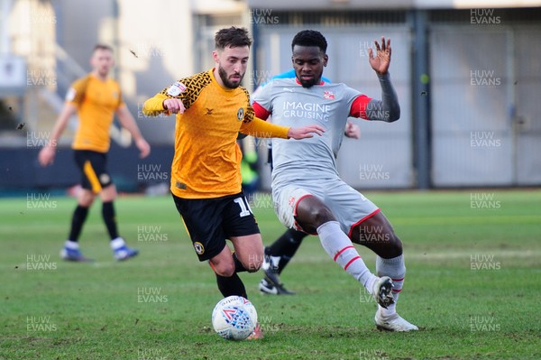 180120 - Newport County v Swindon Town - Sky Bet League 2 - Josh Sheehan of Newport County is tackled by  Diallang Jaiyesimi of Swindon Town