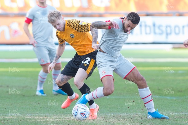 180120 - Newport County v Swindon Town - Sky Bet League 2 - Ashley Baker of Newport County and Kaiyne Woolery of Swindon Town compete for the ball 
