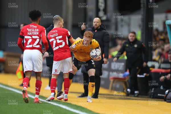 201121 - Newport County v Swindon Town - Sky Bet League 2 - Kaine Kesler-Hayden and Reed of Swindon Town dispute a free kick with Ryan Haines of Newport County
