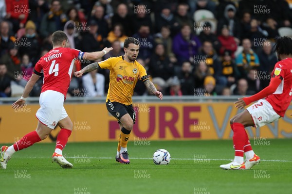 201121 - Newport County v Swindon Town - Sky Bet League 2 - Dom Telford of Newport County looks to shoot past Dion Conroy of Swindon Town