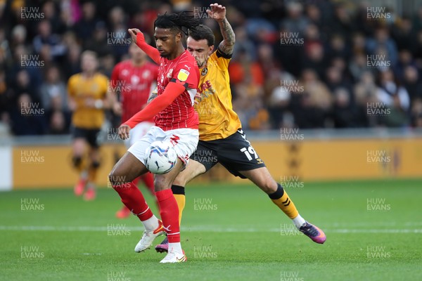 201121 - Newport County v Swindon Town - Sky Bet League 2 - Akinwale Odimayo of Swindon Town gets in front of Dom Telford of Newport County