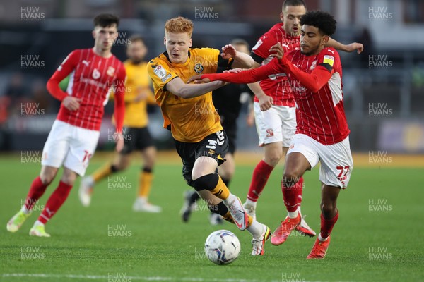 201121 - Newport County v Swindon Town - Sky Bet League 2 - Ryan Haines of Newport County and Kaine Kesler Hayden of Swindon Town battle for the ball