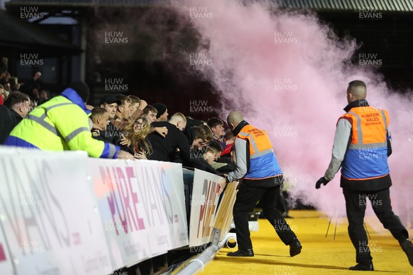 201121 - Newport County v Swindon Town - Sky Bet League 2 - Stewards deal with Swindon fans celebrating their side’s opening goal