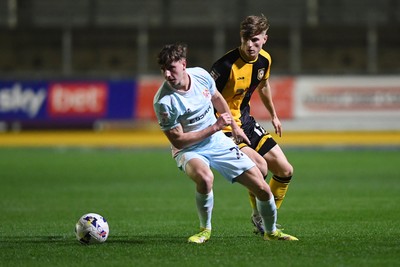 030326 - Newport County v Tranmere Rovers - Sky Bet League 2 - Tom Davies of Newport County is challenged by James Plant of Tranmere