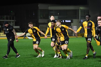 030326 - Newport County v Tranmere Rovers - Sky Bet League 2 - Newport players and staff celebrate the win at full time