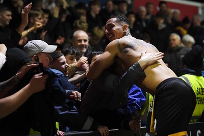 030326 - Newport County v Tranmere Rovers - Sky Bet League 2 - Courtney Baker-Richardson of Newport County celebrates with fans at full time