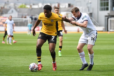 030525 - Newport County v Tranmere Rovers - Sky Bet League 2 - Bobby Kamwa of Newport County is challenged by Chris Merrie of Tranmere Rovers