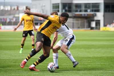030525 - Newport County v Tranmere Rovers - Sky Bet League 2 - Bobby Kamwa of Newport County is challenged by Chris Merrie of Tranmere Rovers