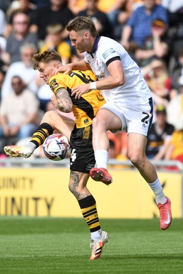 030525 - Newport County v Tranmere Rovers - Sky Bet League 2 - Kai Whitmore of Newport County is challenged by Cameron Norman of Tranmere Rovers