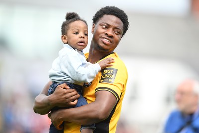 030525 - Newport County v Tranmere Rovers - Sky Bet League 2 - Bobby Kamwa of Newport County walks out with family at the start boo the match