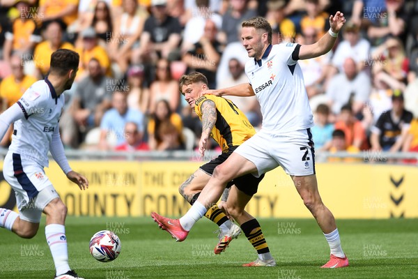 030525 - Newport County v Tranmere Rovers - Sky Bet League 2 - Kai Whitmore of Newport County is challenged by Cameron Norman of Tranmere Rovers