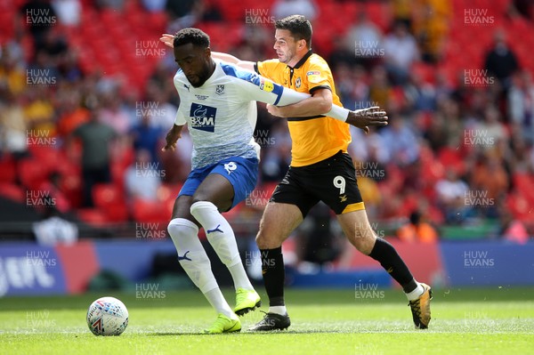 250519 - Newport County v Tranmere Rovers - SkyBet League Two Play-off Final - Padraig Amond of Newport County is challenged by Jake Caprice of Tranmere Rovers