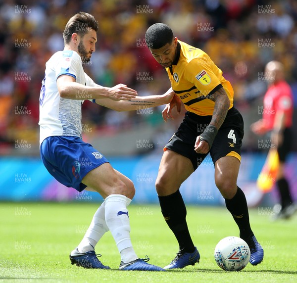 250519 - Newport County v Tranmere Rovers - SkyBet League Two Play-off Final - Joss Labadie of Newport County is tackled by Oliver Banks of Tranmere Rovers