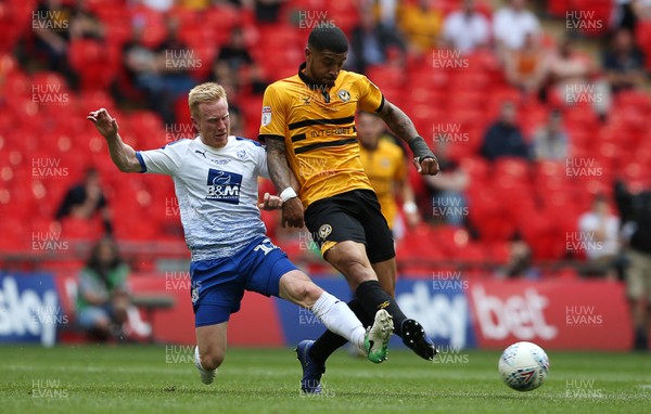 250519 - Newport County v Tranmere Rovers - SkyBet League Two Play-off Final - Joss Labadie of Newport County is tackled by David Perkins of Tranmere Rovers