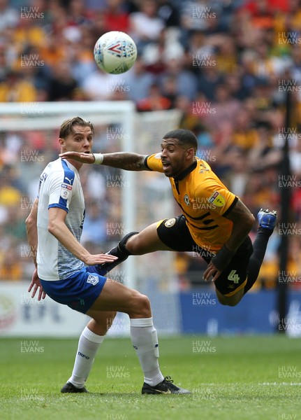 250519 - Newport County v Tranmere Rovers - SkyBet League Two Play-off Final - Joss Labadie of Newport County is tackled by Sid Nelson of Tranmere Rovers