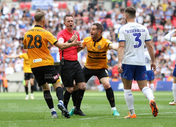 250519 - Newport County v Tranmere Rovers, Sky Bet League 2 Play-Off Final - Mickey Demetriou of Newport County and Matty Dolan of Newport County appeal to referee Ross Joyce after Jamille Matt of Newport County is brought down by Emmanuel Monthe of Tranmere Rovers but is denied a penalty