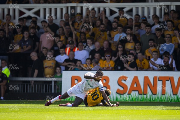 050822 - Newport County v Walsall - Sky Bet League 2 - Offrande Zanzala of Newport County is fouled by Donervon Daniels of Walsall