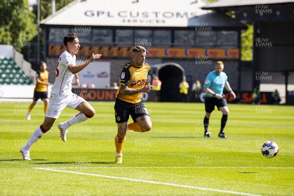 050822 - Newport County v Walsall - Sky Bet League 2 - Scot Bennett of Newport County in action against Isaac Hutchinson of Walsall